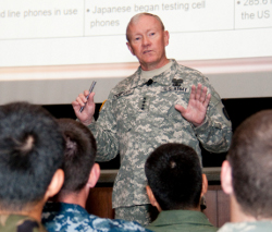 Military lecture in front of a slide presentation