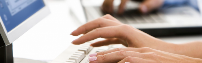 fingers typing on a computer keyboard