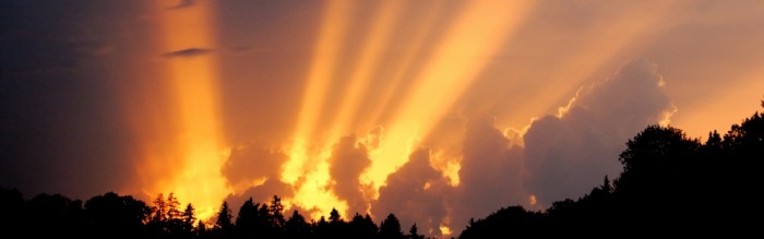 sun rays shining through clouds