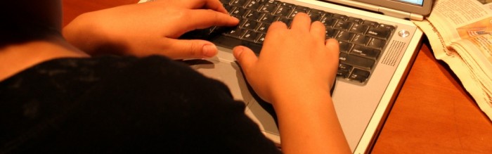 person typing on a laptop