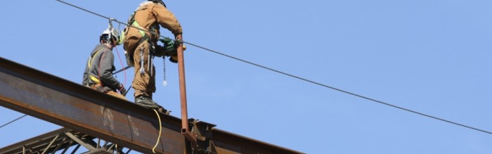 workers standing on beams 